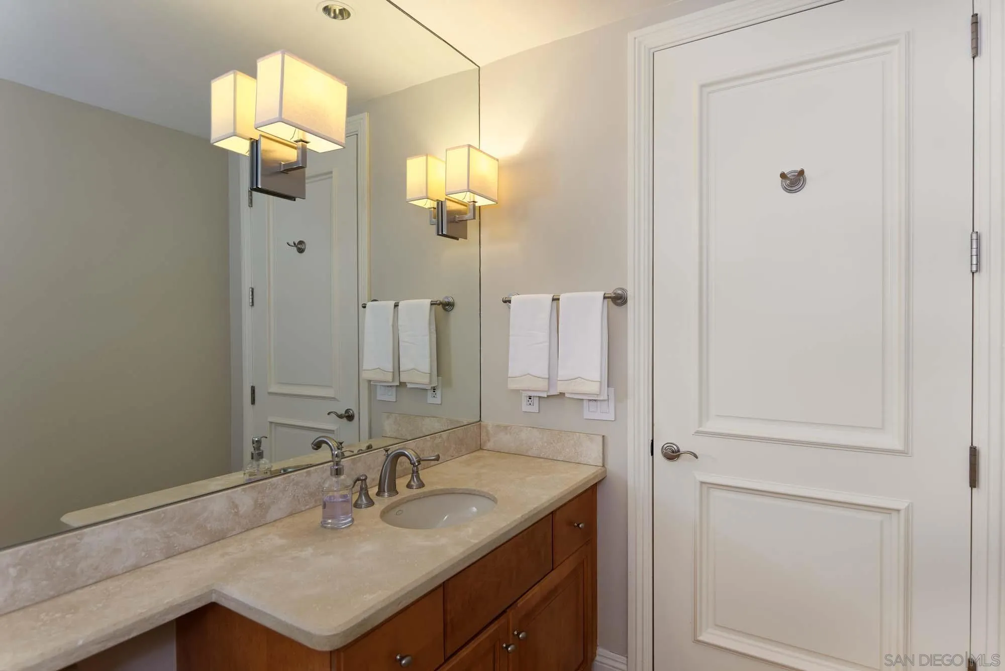 464 Prospect Street, Unit 101 La Jolla, CA 92037 - Photo 17 of 43 a bathroom with a sink vanity and a mirror