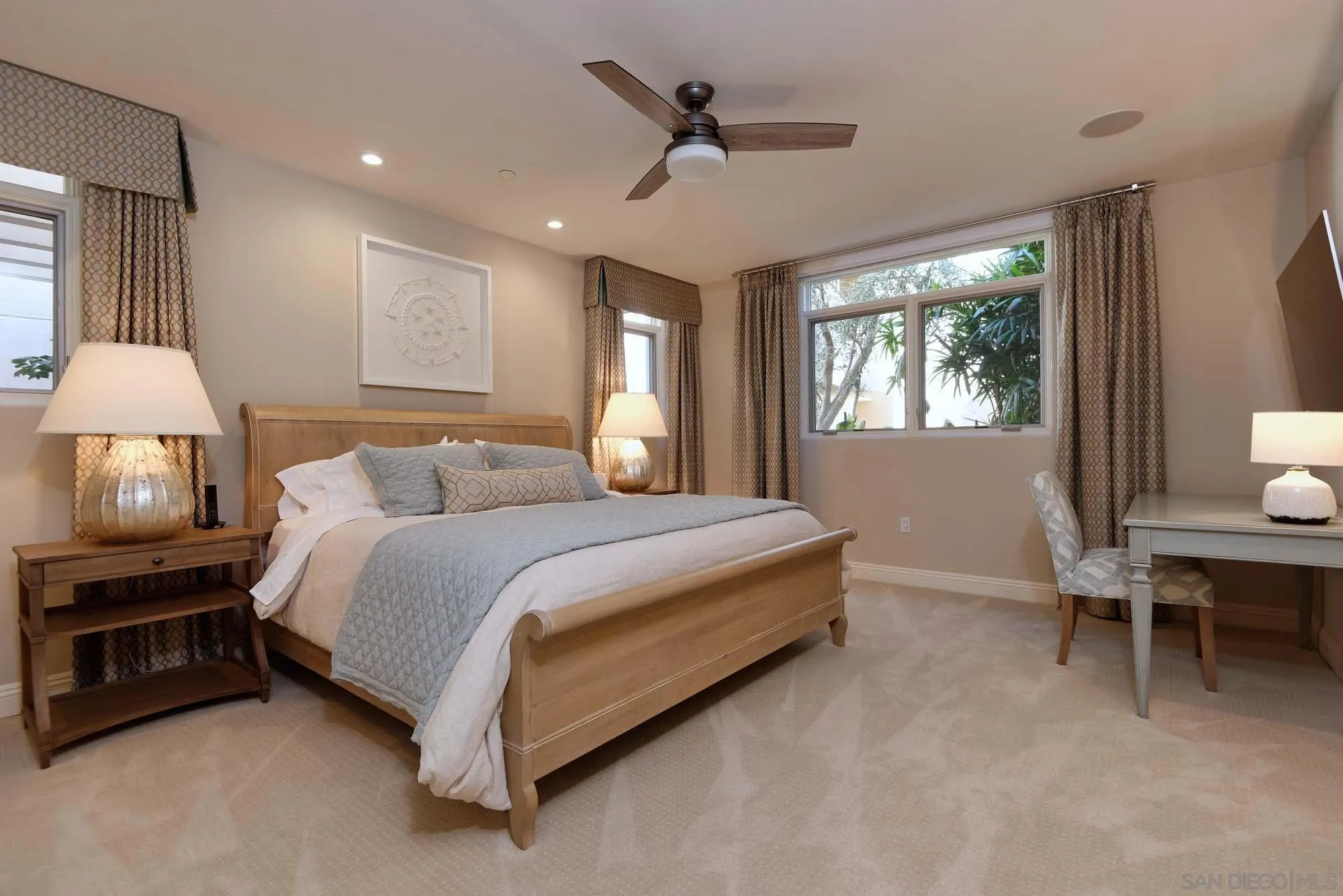 464 Prospect Street, Unit 101 La Jolla, CA 92037 - Photo 18 of 43 a spacious bedroom with a bed a chandelier and a window