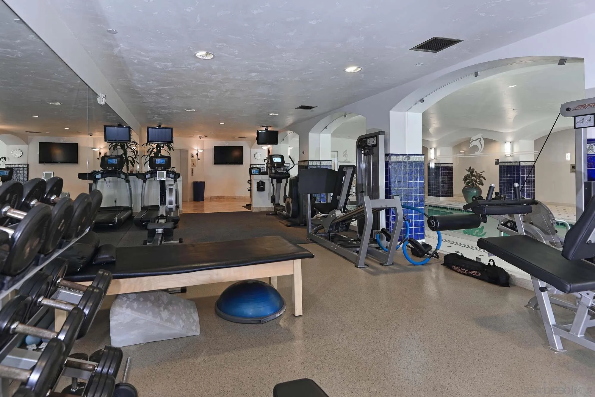 464 Prospect Street, Unit 101 La Jolla, CA 92037 - Photo 37 of 43 a room with gym equipment and a flat screen tv