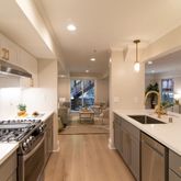 a kitchen with stainless steel appliances a sink stove and cabinets