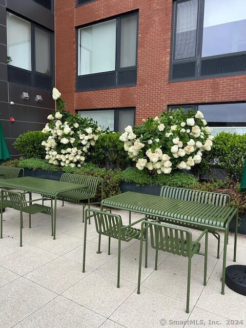42 John Street, Unit 506 Stamford, CT 06902 - Photo 12 of 23 a view of a chair and table in the backyard
