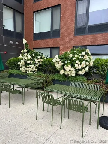 a view of a chair and table in the backyard