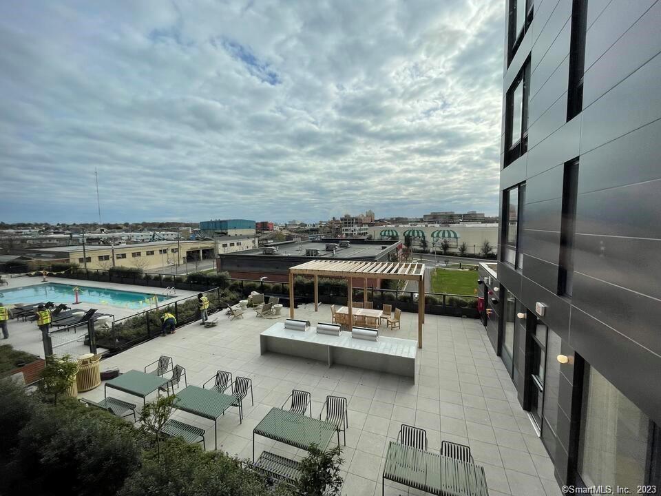 42 John Street, Unit 506 Stamford, CT 06902 - Photo 2 of 23 a view of a chairs and table on the terrace