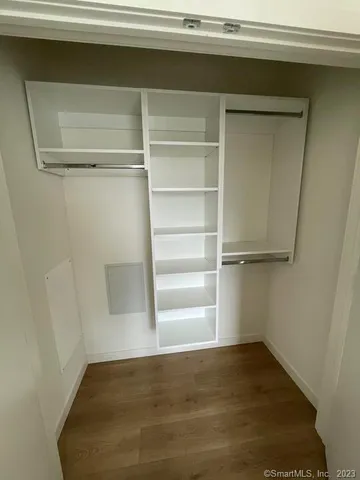 a view of a room with a wooden floor and a window