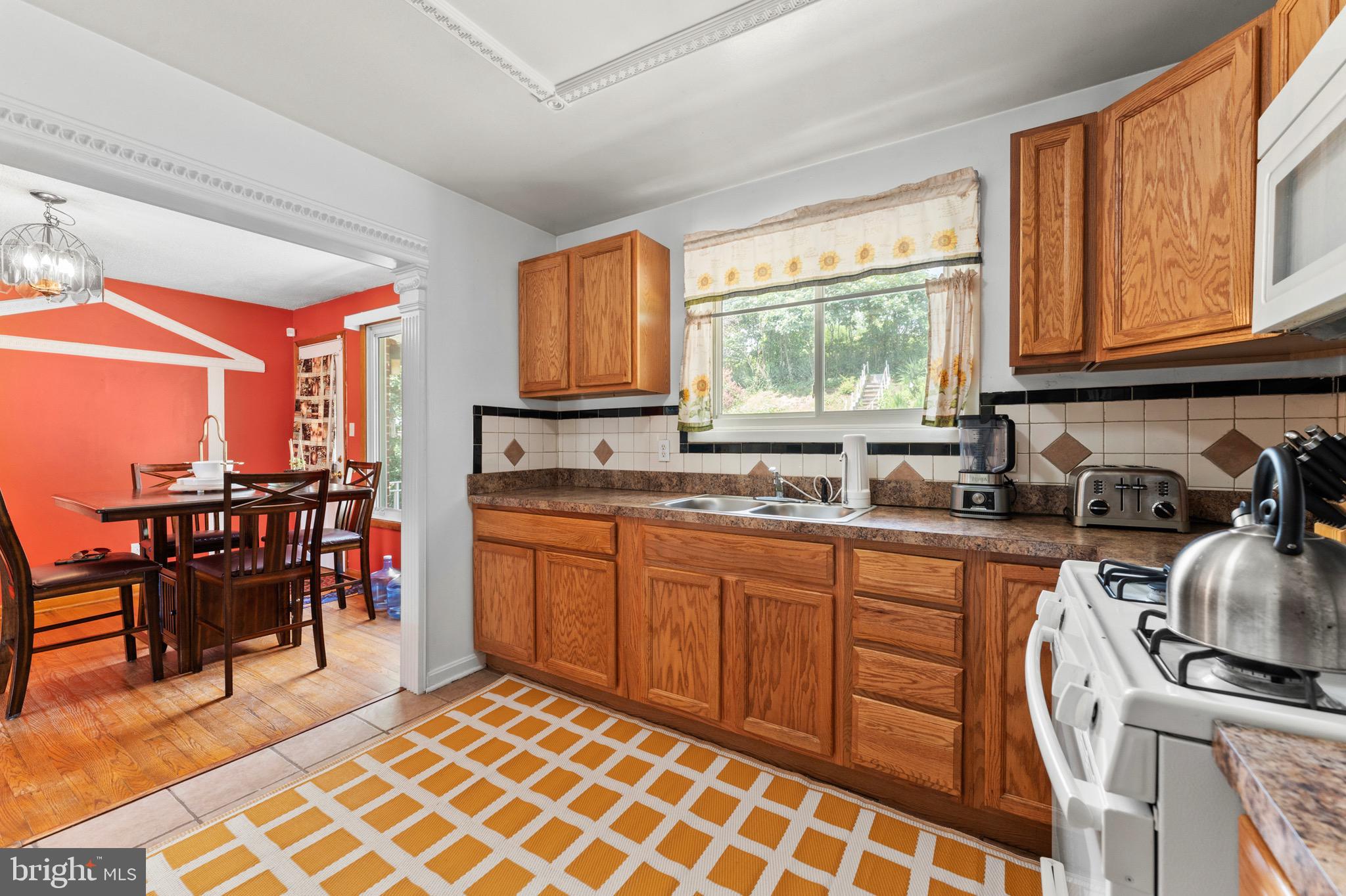 8426 Avery Road Baltimore, MD 21237 - Photo 12 of 25 a kitchen with stainless steel appliances granite countertop a sink stove and cabinets