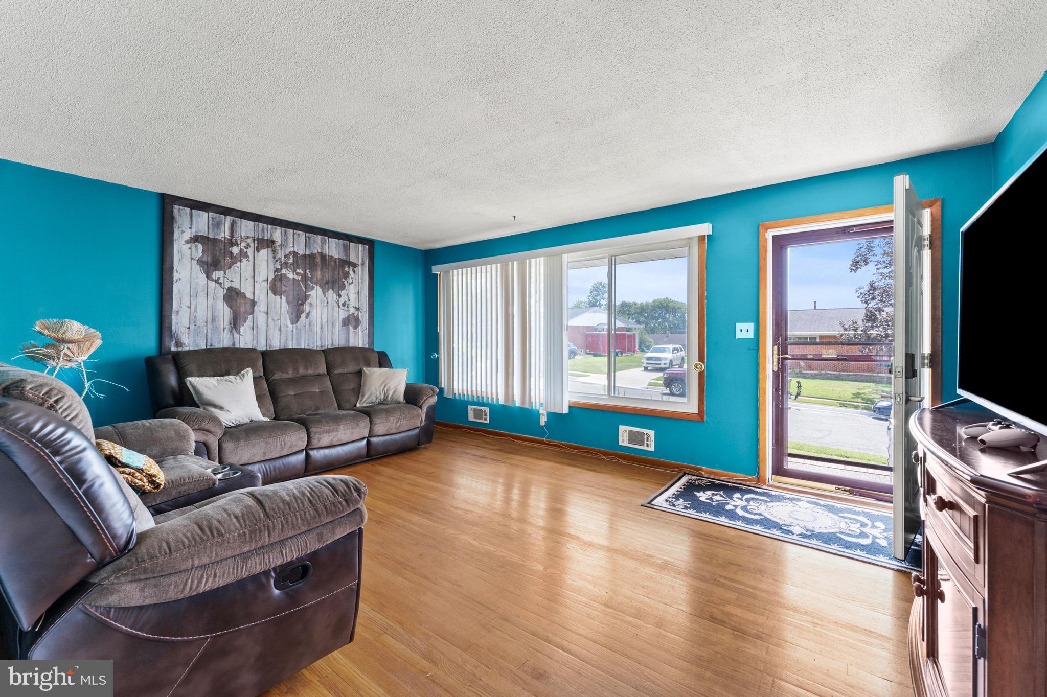 8426 Avery Road Baltimore, MD 21237 - Photo 7 of 25 a living room with furniture and a flat screen tv