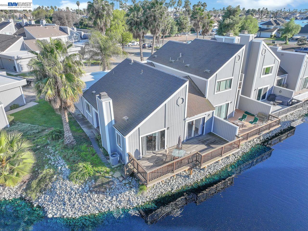 an aerial view of residential houses with yard and ocean view