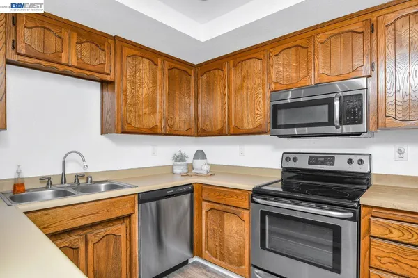 a kitchen with stainless steel appliances granite countertop a sink stove and microwave