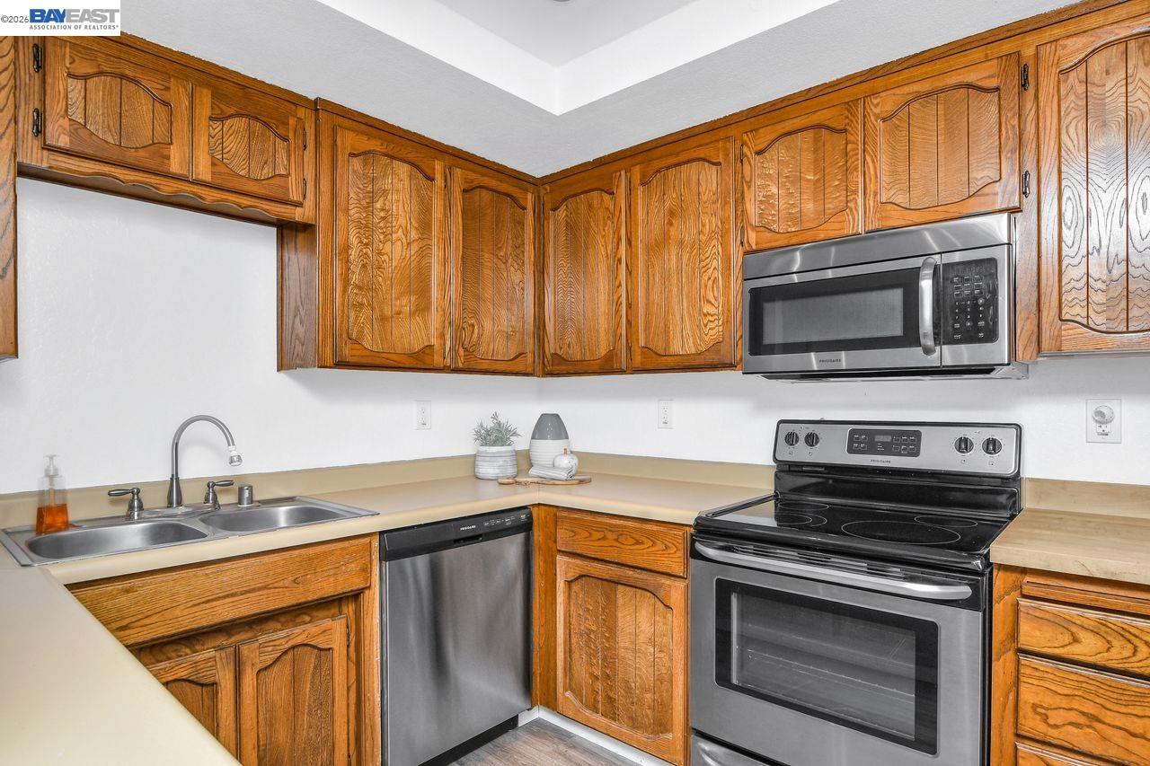 2033 Sand Point Road Discovery Bay, CA 94505 - Photo 11 of 27 a kitchen with stainless steel appliances granite countertop a sink stove and microwave