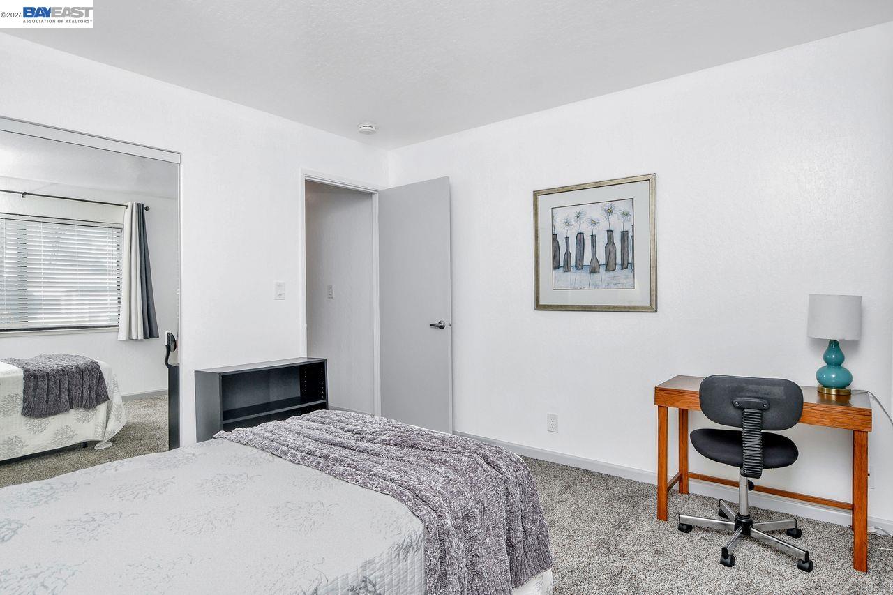2033 Sand Point Road Discovery Bay, CA 94505 - Photo 15 of 27 a bedroom with a bed and a chair in it