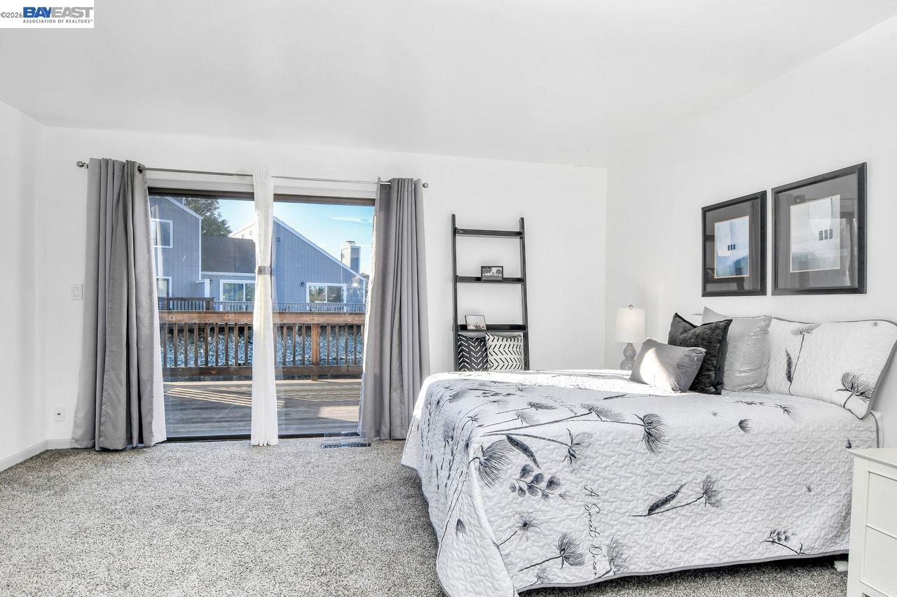2033 Sand Point Road Discovery Bay, CA 94505 - Photo 19 of 27 a bedroom with a bed and a large window