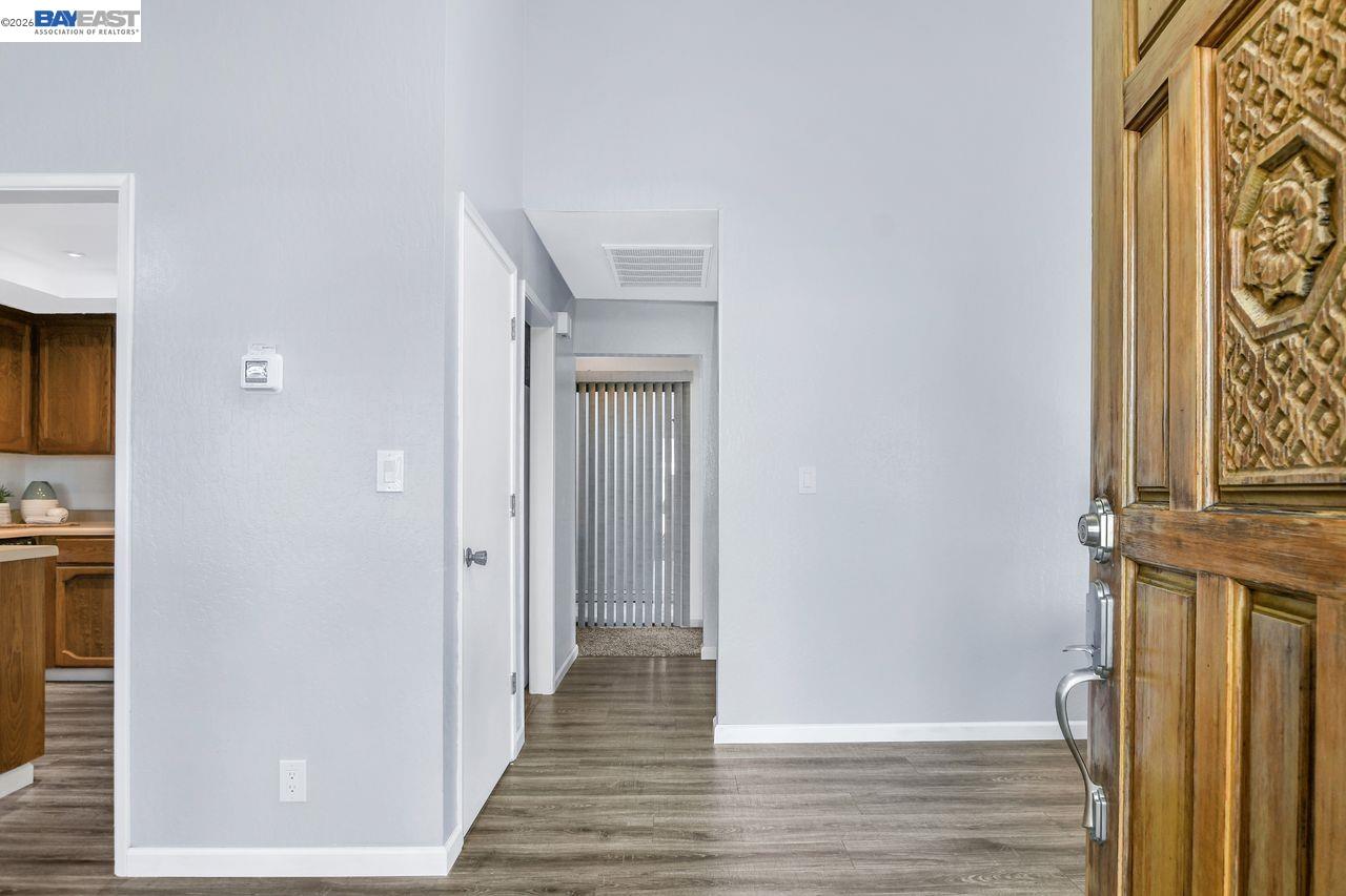 2033 Sand Point Road Discovery Bay, CA 94505 - Photo 5 of 27 a view of a hallway with wooden floor and staircase