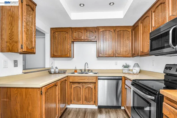 a kitchen with stainless steel appliances granite countertop a sink stove microwave and cabinets
