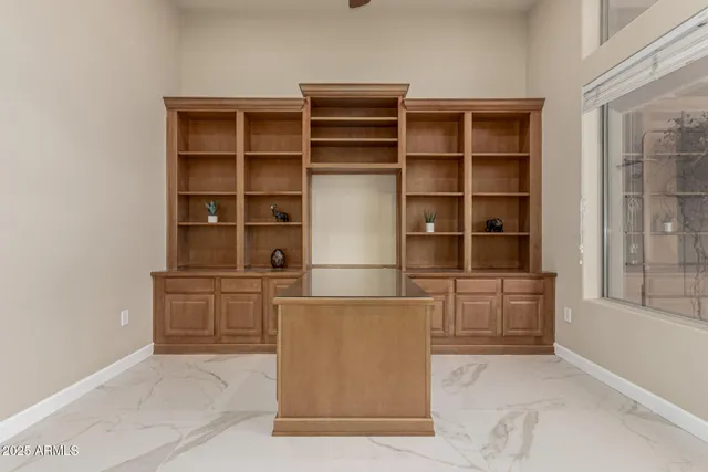 a dining hall with stainless steel appliances a table and chairs