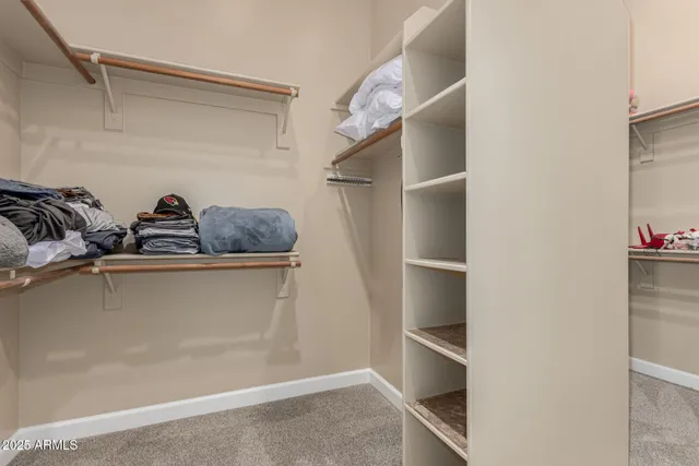 an empty room with closet and windows