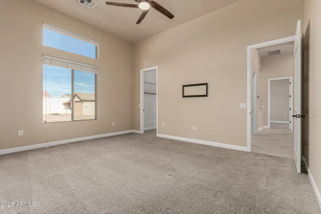 a dining room with furniture and a floor to ceiling window