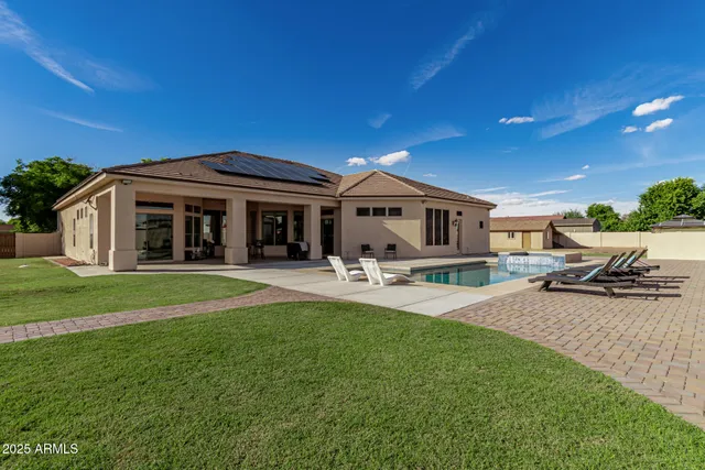 an aerial view of a house with swimming pool and lake view