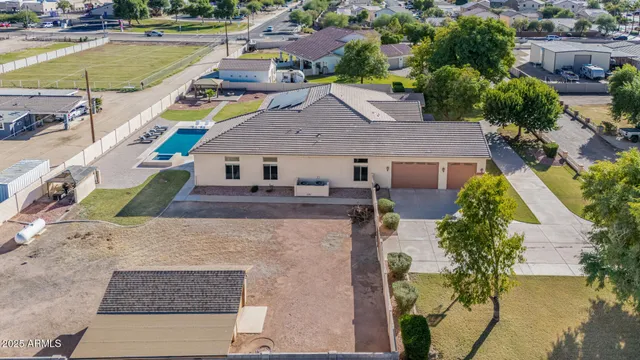 a view of a white house with a yard and plants