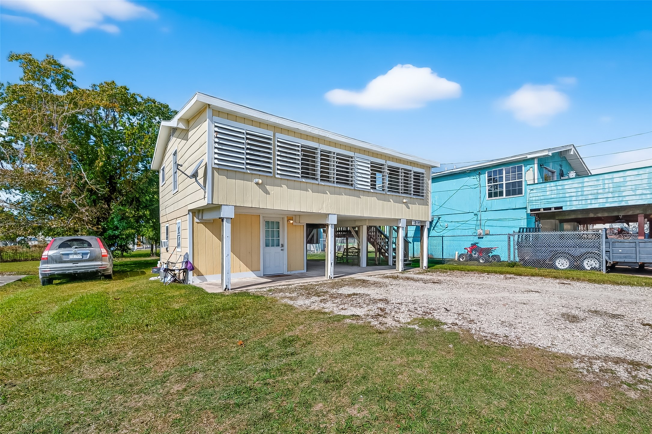 1012 12th Street, Unit UP Dickinson, TX 77539 - Photo 2 of 18 a front view of a house with a yard and trees