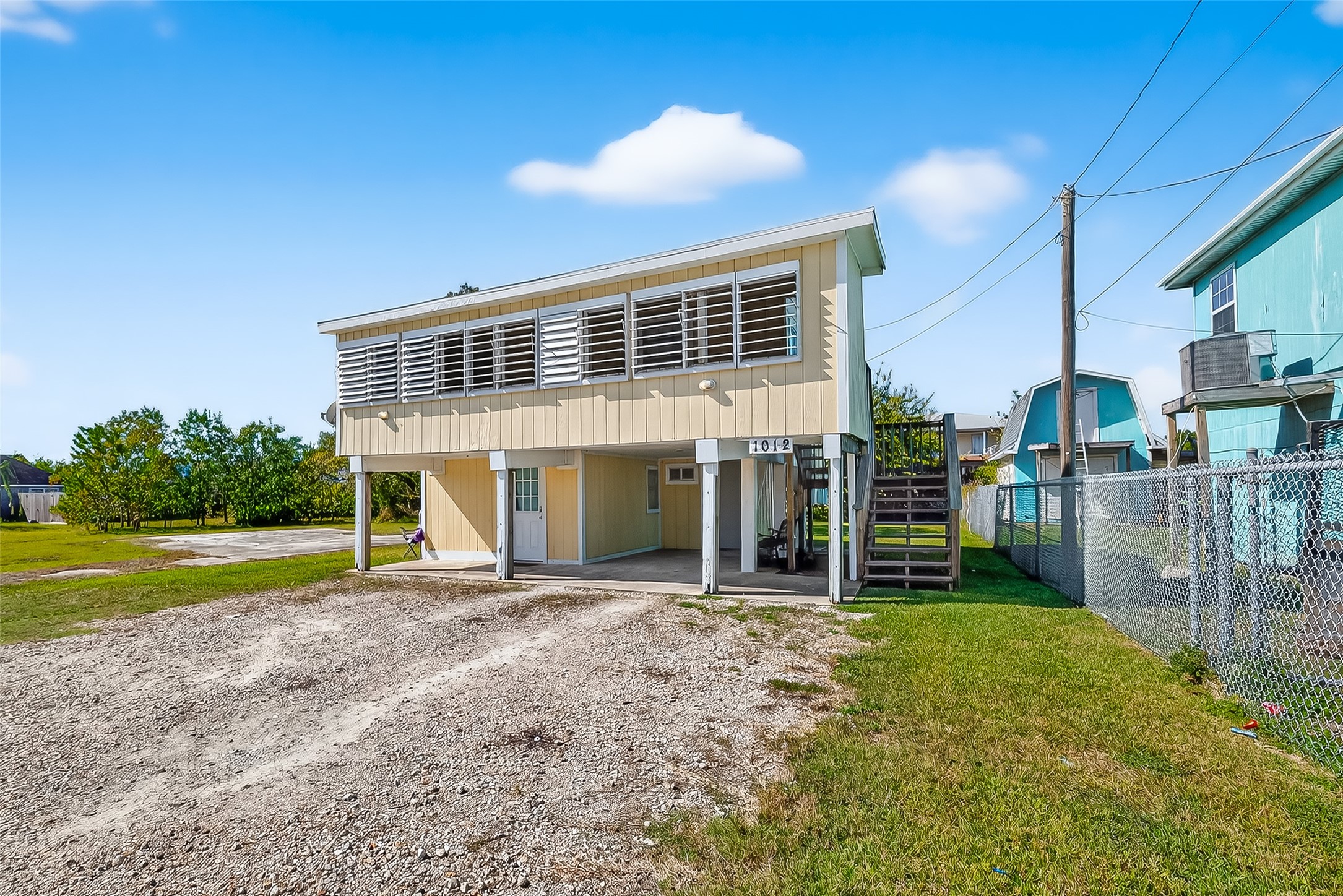 1012 12th Street, Unit UP Dickinson, TX 77539 - Photo 3 of 18 a view of a house with a yard