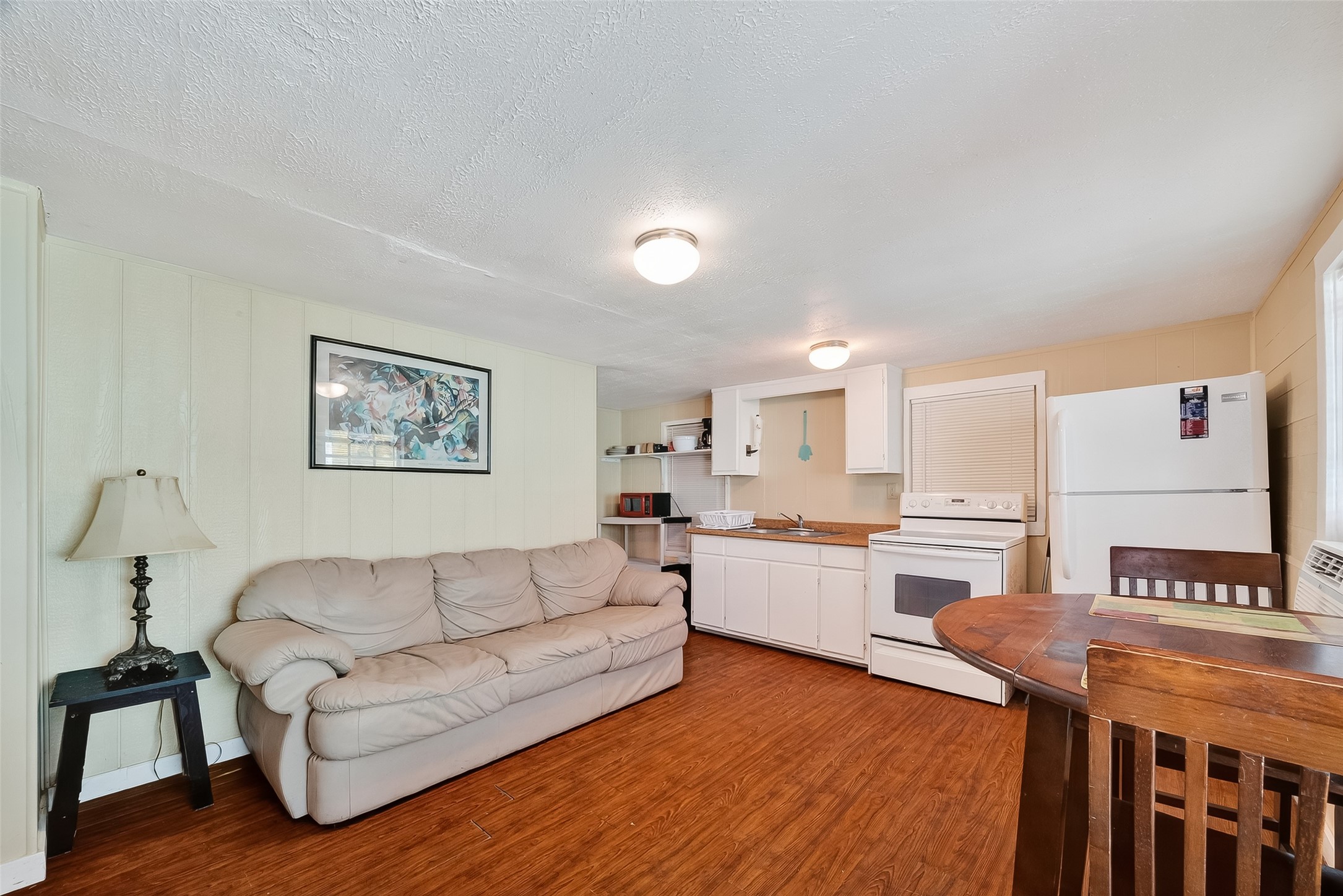 1012 12th Street, Unit UP Dickinson, TX 77539 - Photo 6 of 18 a living room with stainless steel appliances granite countertop furniture and a wooden floor