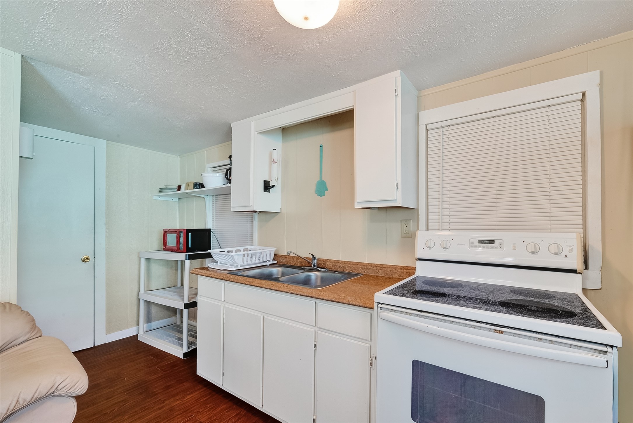 1012 12th Street, Unit UP Dickinson, TX 77539 - Photo 8 of 18 a kitchen with a stove cabinets and wooden floor