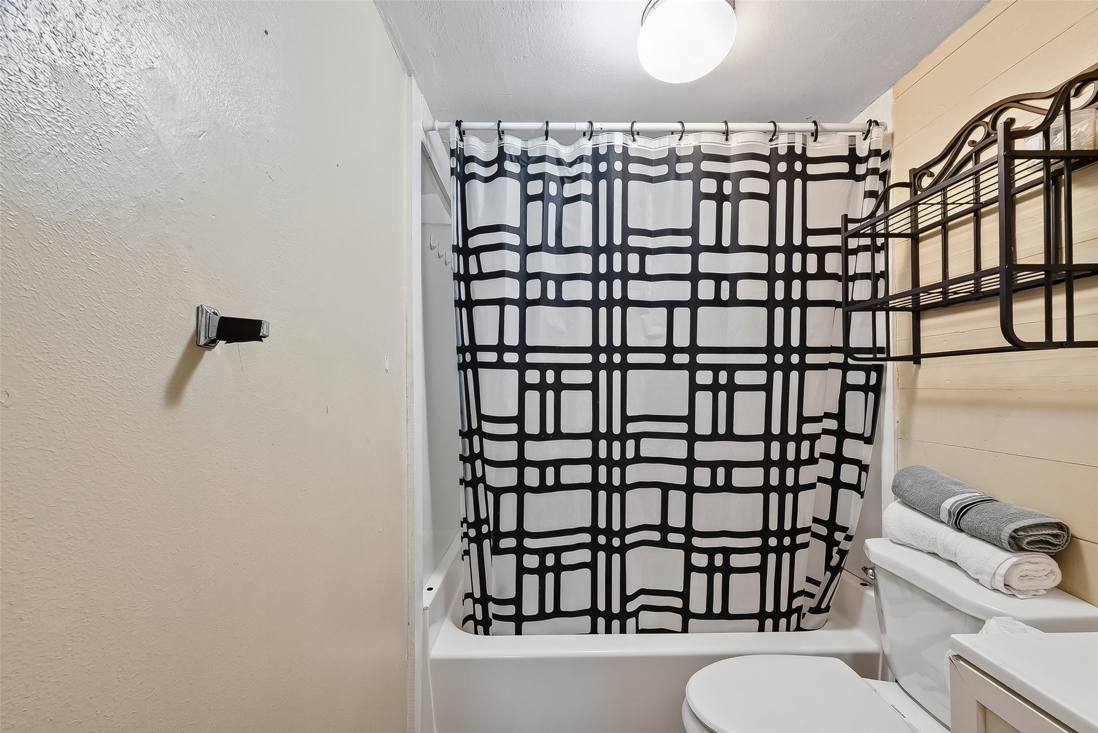 1012 12th Street, Unit UP Dickinson, TX 77539 - Photo 10 of 18 a bathroom with a toilet and a shower curtain