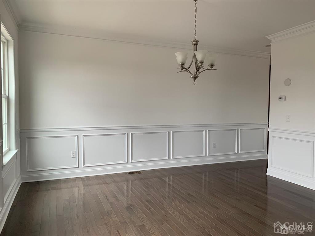 21 May Road East Brunswick, NJ 08816 - Photo 10 of 18 an empty room with wooden floor cabinet and windows