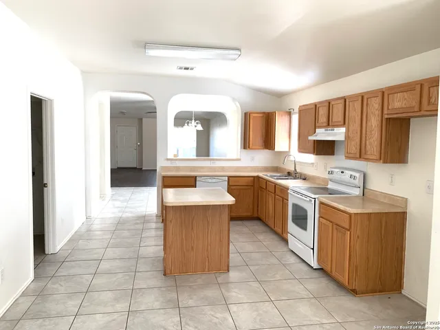 a kitchen with a sink counter top space and appliances