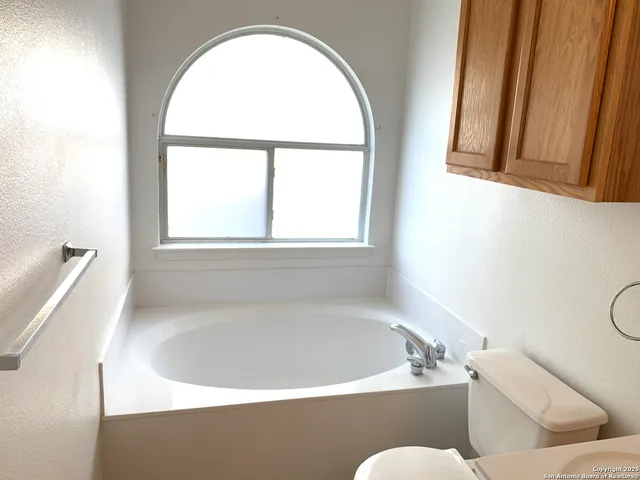 a bath tub sitting in a bathroom next to a window