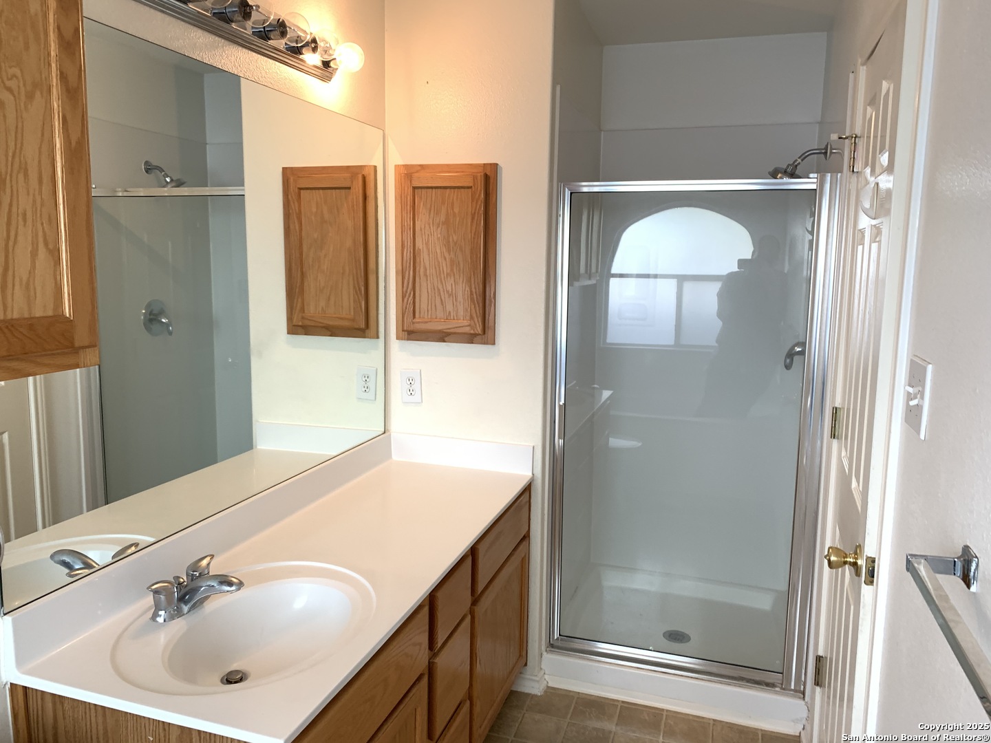 531 Rattler Bluff San Antonio, TX 78251 - Photo 21 of 36 a bathroom with a shower sink and mirror