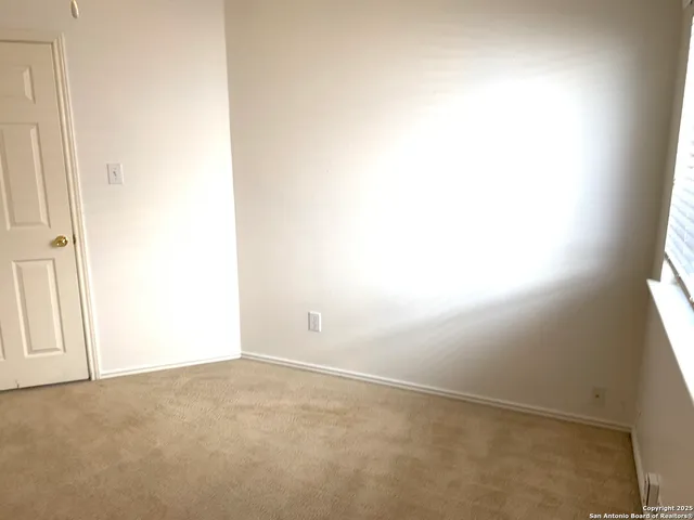 a view of an empty room and a window