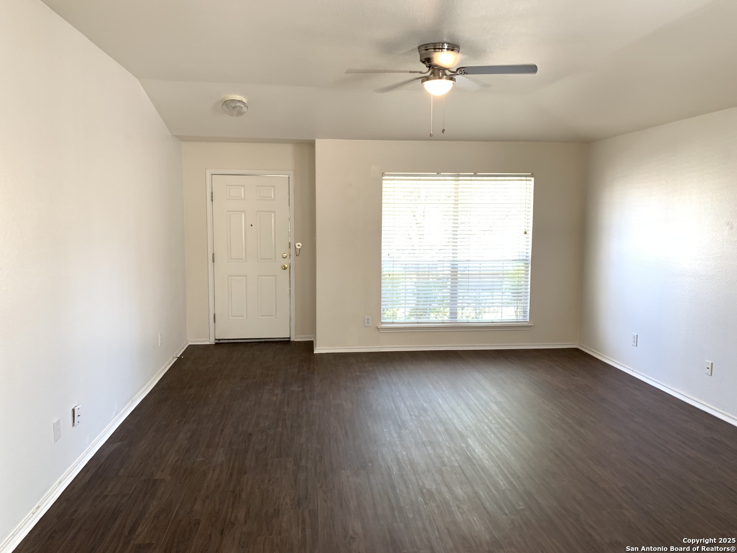 531 Rattler Bluff San Antonio, TX 78251 - Photo 35 of 36 an empty room with wooden floor chandelier fan and windows