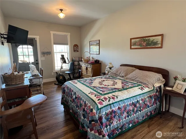 a bedroom with a bed a couch and dresser