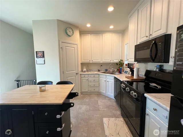 a kitchen with a sink stove and refrigerator