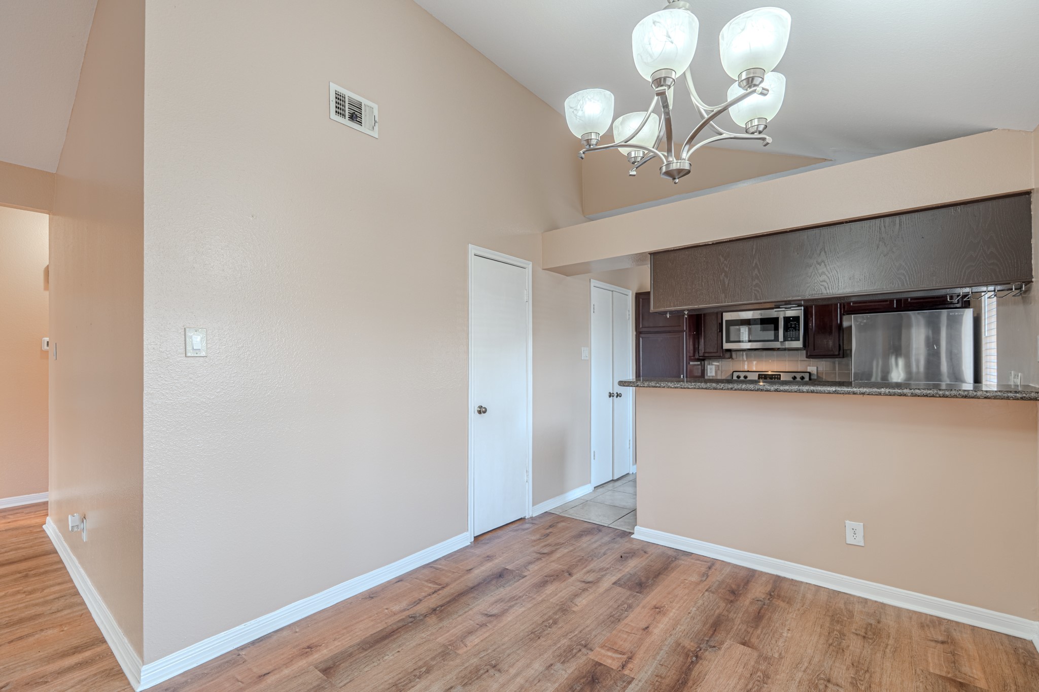 3500 Tangle Brush Drive, Unit 182 Spring, TX 77381 - Photo 13 of 24 a view of a hallway with wooden floor and chandelier