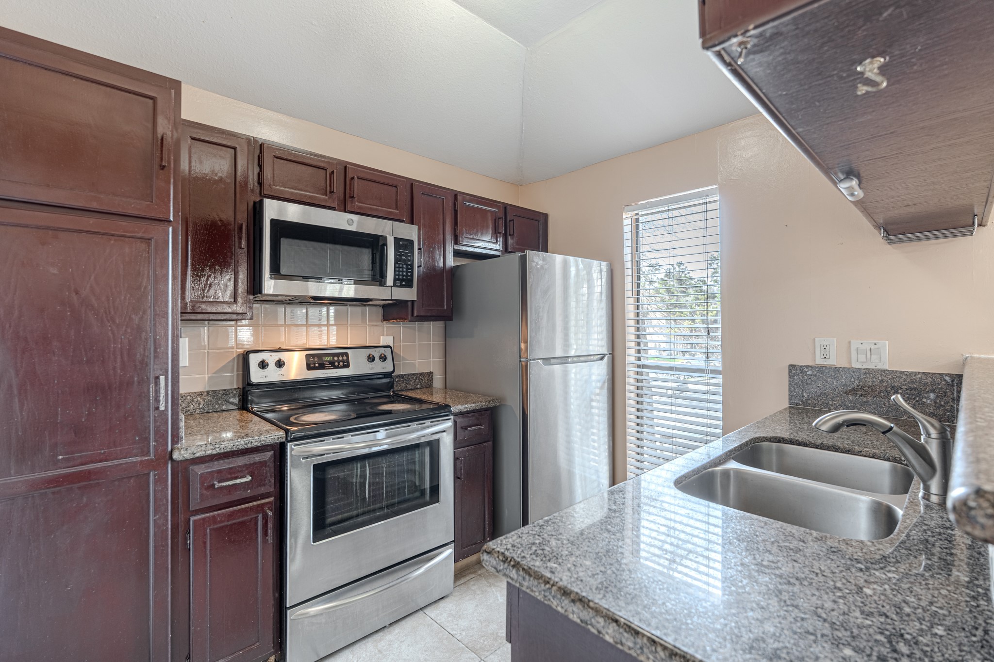 3500 Tangle Brush Drive, Unit 182 Spring, TX 77381 - Photo 14 of 24 a kitchen with stainless steel appliances granite countertop a refrigerator stove and sink