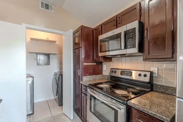 a kitchen with a stove and a microwave