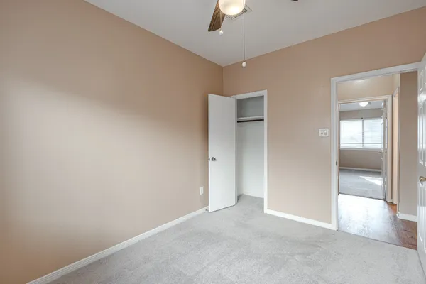 an empty room with ceiling fan
