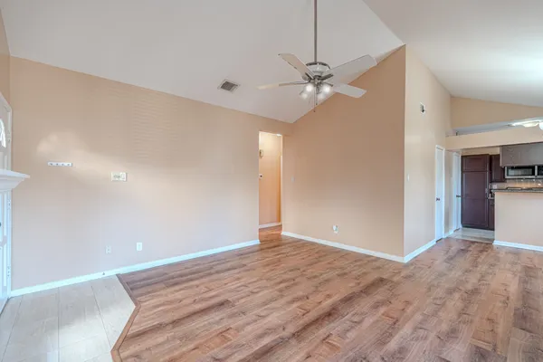 a view of an empty room with a ceiling fan