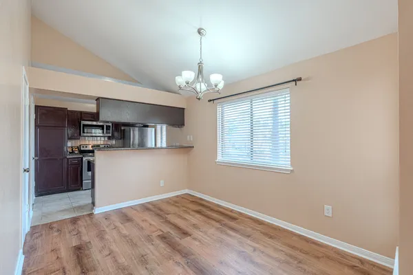 a view of a kitchen with a sink wooden floor and a kitchen