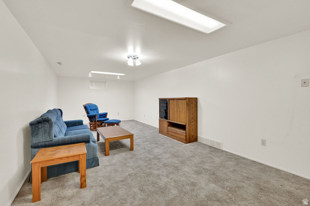 2467 South 2000 West Syracuse, UT 84075 - Photo 20 of 28 Spacious room featuring neutral carpeting, white walls, and bright overhead lighting