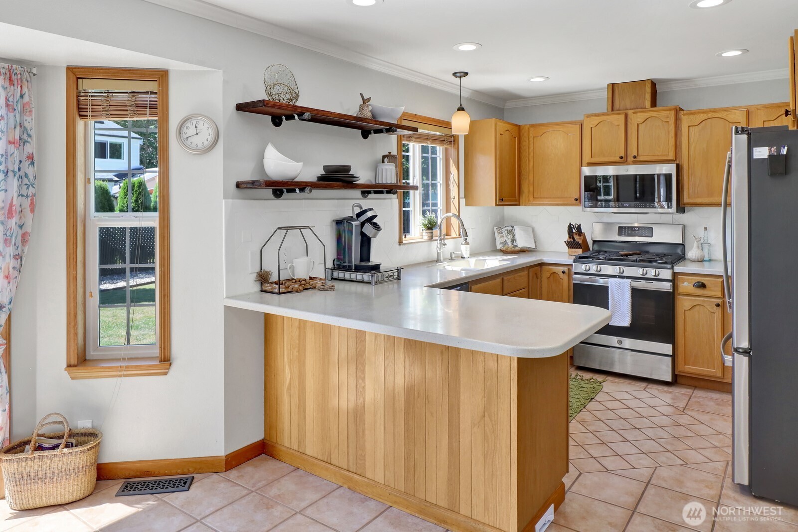 6149 Church Road Ferndale, WA 98248 - Photo 11 of 37 a kitchen with stainless steel appliances granite countertop a sink a stove and a refrigerator