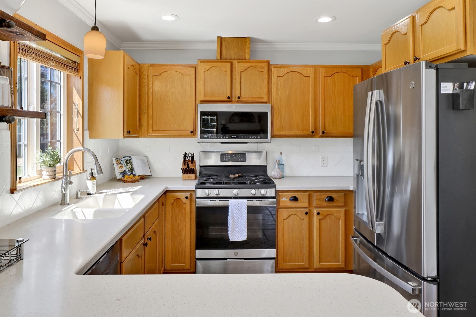 6149 Church Road Ferndale, WA 98248 - Photo 12 of 37 a kitchen with stainless steel appliances granite countertop a stove a sink and a refrigerator