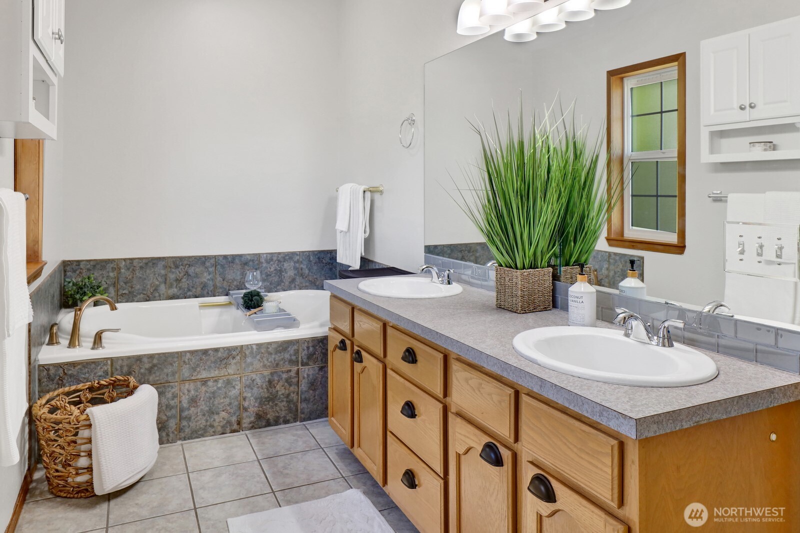 6149 Church Road Ferndale, WA 98248 - Photo 22 of 37 a spacious bathroom with a double vanity sink a mirror and a bathtub