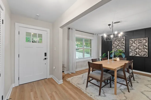 a view of a dining room with furniture window and wooden floor