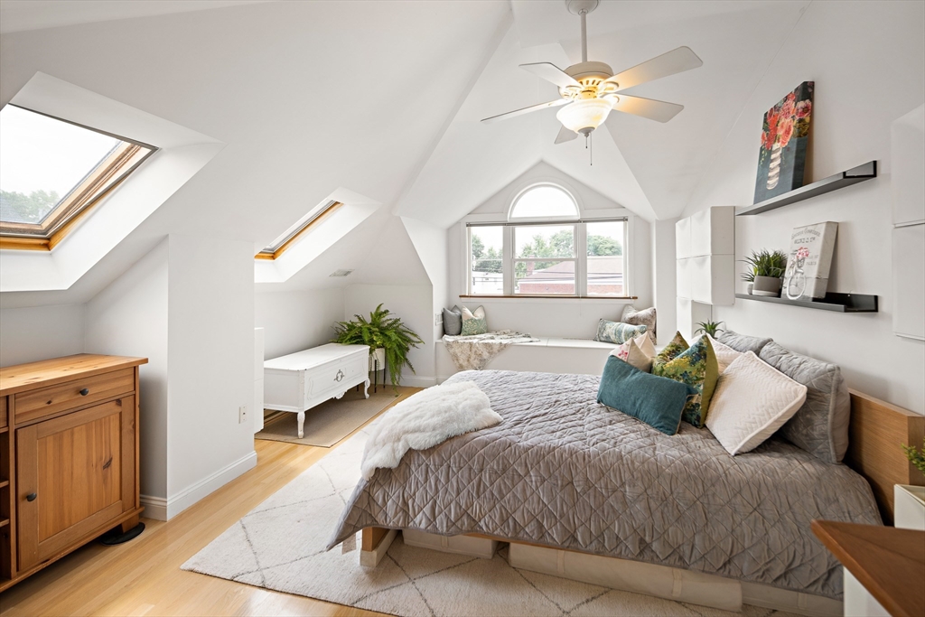 32 Harvard Street, Unit 2 Waltham, MA 02453 - Photo 11 of 32 a bedroom with a bed and a chandelier