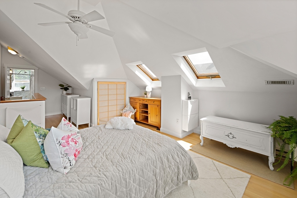 32 Harvard Street, Unit 2 Waltham, MA 02453 - Photo 12 of 32 a bedroom with a bed and a potted plant