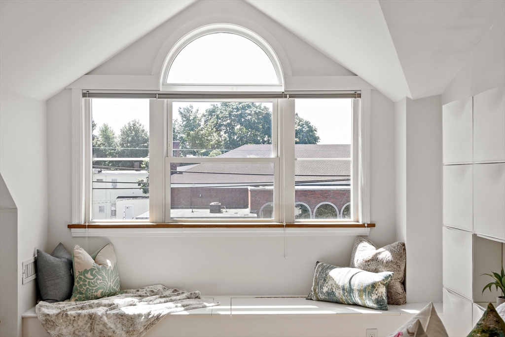 32 Harvard Street, Unit 2 Waltham, MA 02453 - Photo 13 of 32 a bedroom with a bed and a large window