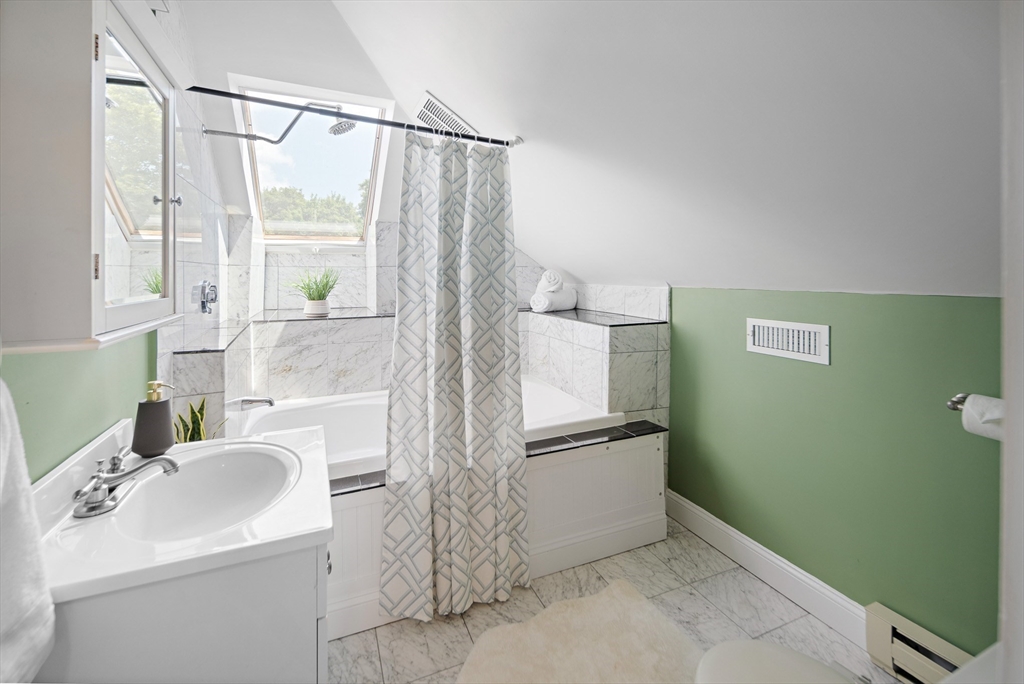 32 Harvard Street, Unit 2 Waltham, MA 02453 - Photo 19 of 32 a bathroom with a sink and a mirror